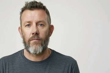 Fototapeta premium Portrait of pensive middle aged man against white background