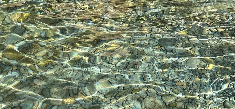 Stones and pebbles in clear sea water