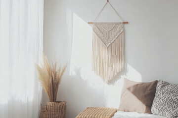 A serene, minimalist interior featuring a macrame wall hanging and pampas grass in a woven basket, illuminated by soft sunlight.

