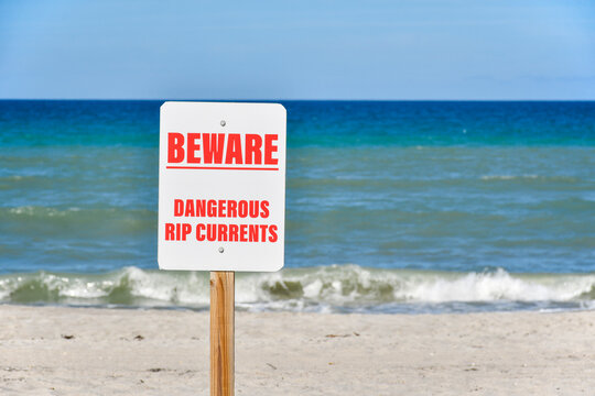 Dangerous rip current signs posted on Florida beach. 