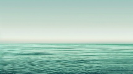 Obraz premium A minimalist background featuring a gradient of green shades, evoking a calm ocean or sky.