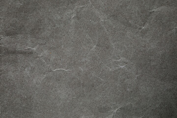 Crumpled dark grey paper background texture