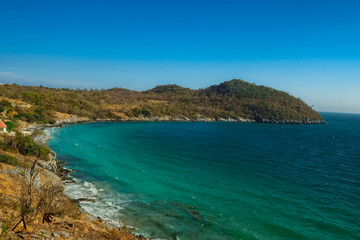 Fototapeta premium Aerial panorama of Thailand's verdant, with blue and aquamarine the sea, and clouds shining by sunlight in the background.