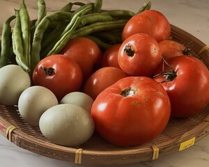 Close up of Basket of local produce from farmers market, green beans, tomatoes and duck eggs