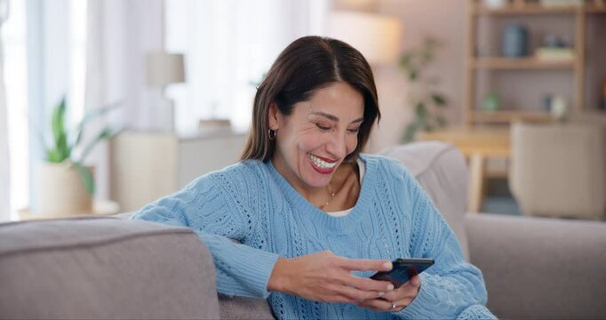 Woman, relax and laughing on sofa with phone for funny text message, social media meme or online joke in home. Person, smartphone and happy in lounge with streaming subscription and fun mobile chat
