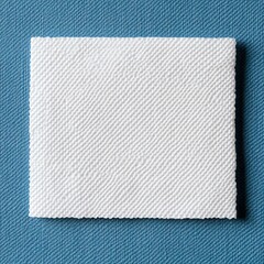 Blank white woven label tag on blue background.
