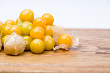 Cape gooseberry (Physalis peruviana) on wooden background. Copy space.