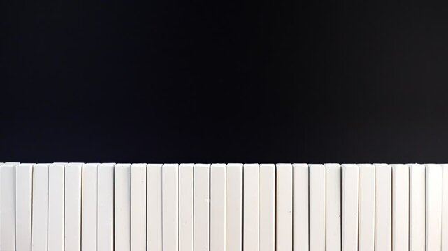row of white chalks on black board, concept of advert in education or business, motion, copy space