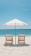 Fototapeta premium Two empty beach chairs under a white umbrella facing the calm ocean on a sunny day, perfect for relaxation and vacation imagery.
