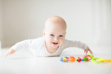 Little baby on white floor