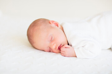 Little baby on white bed