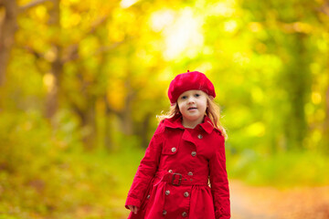 Little girl in autumn park