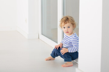 Toddler child in white bedroom