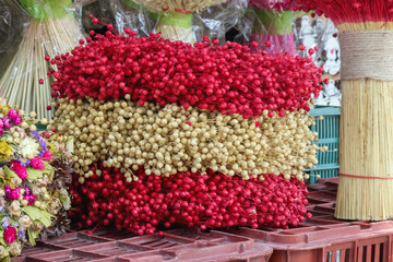 bouquets of flowers in the market are arranged in red, white and red colors