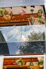 
a collage of a restaurant with various decorations behind a glass wall