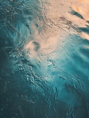 Fototapeta premium The image is of a body of water with ripples and waves. The water appears to be calm and peaceful, with a sense of serenity and tranquility. The blue color of the water is soothing and calming