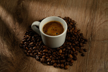 Cup of coffee and beans on a table.