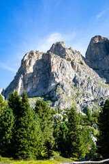 Majestic granite cliffs rise brilliantly against a clear blue sky in a serene mountain landscape during the summer months