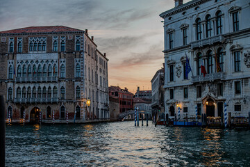 Historic Venetian architecture along a tranquil canal at sunset, showcasing the beauty of Venice and its serene waterways