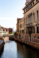 Naklejka premium Quiet morning in a historic Venetian canal with charming architecture and a tranquil atmosphere in early daylight
