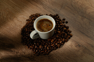 Espresso coffee cup on vintage table with roasted coffee beans