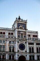 Naklejka premium Historical Venetian clock tower showcasing intricate architecture and vibrant mosaics under a clear blue sky