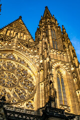 St. Vitus Cathedral illuminated by golden sunlight during the late afternoon in Prague, showcasing...