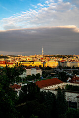 Fototapeta premium Golden light bathes the historic skyline of Ljubljana, Slovenia during the evening with clouds creating a dramatic backdrop
