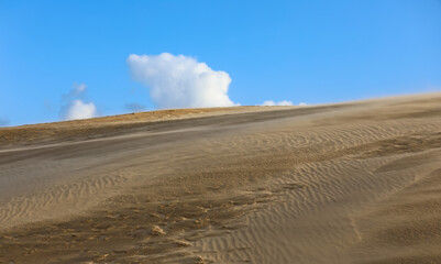 sand dunes and the blue sky with some clouds without people