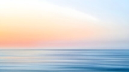 Obraz premium A blurred seascape at sunrise with soft pastel colors blending into the horizon, conveying a sense of tranquility