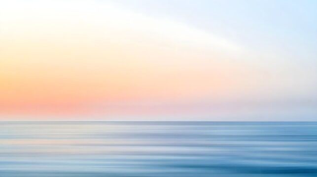 A blurred seascape at sunrise with soft pastel colors blending into the horizon, conveying a sense of tranquility
