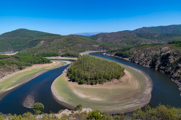 View of the Melendo Meander of the Alagon River with forests and hills between the Spanish...