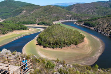 View of the Melendo Meander of the Alagon River with forests and hills between the Spanish...