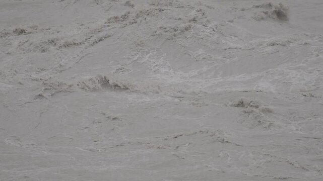 Turbulent muddy waters massive rapids in a river 