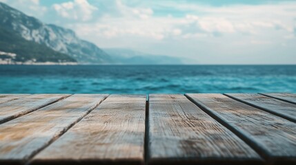 Fototapeta premium Closeup shot of a wooden table with sea in the background.