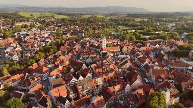 A stunning aerial video capturing the picturesque old town of Wangen im Allgaeu, Baden-Wuerttemberg, Germany. This drone footage showcases the red-tiled rooftops, medieval architecture, and the centra