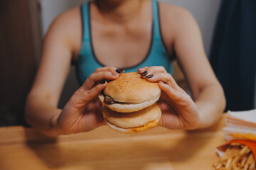 Binge eating disorder concept with woman eating fast food burger, fired chicken , donuts and desserts