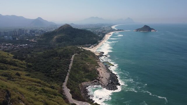 Aerial view of Recreio dos Bandeirantes, Macumba e Praia do Secreto near Prainha beach, in Rio de Janeiro, Brazil. Big hills around. Sunny day. Drone take.