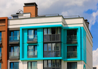 City view on a sunny day. Modern building and houses against the blue sky.