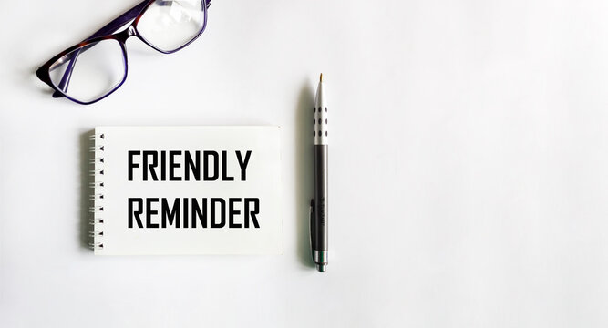 Friendly reminder text on note pad with a pen - A reminder to perform certain task
