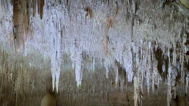 Background. Stalactites in the cave fill the upper part of the cave in large numbers

