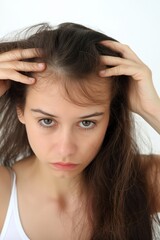 Obraz premium sad woman with damaged hair that is falling out