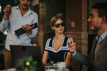 Business professionals engaging in a meeting at an outdoor cafe, showcasing teamwork, collaboration, and modern networking in a relaxed atmosphere.