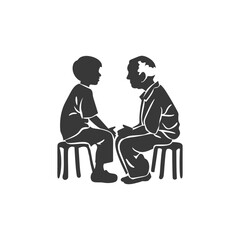 A young boy and older man sit facing each other on stools