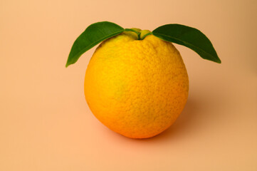 Ripe orange on a beige background