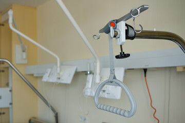 Hospital bed trapeze lift bar. Triangle in a hospital bed adapted to the sick, help and support.