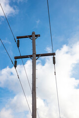 Photograph looking up at the top of a wooden telephone pole in a remote location in the Blue...