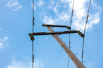 Photograph looking up at the top of a wooden telephone pole in a remote location in the Blue...