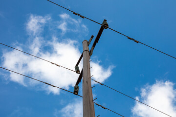 Photograph looking up at the top of a wooden telephone pole in a remote location in the Blue...