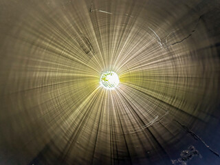 Photograph of the inside of a large section of black high density polyethylene HDPE pipe with the...